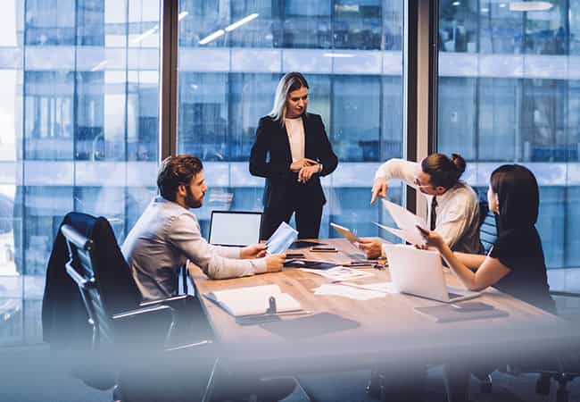 denver real estate colleagues discuss market trends around a conference table